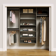 Grey 82.5-inch woodgrain Vista Total Closet Kit, front view in a reach-in closet, holding dresses