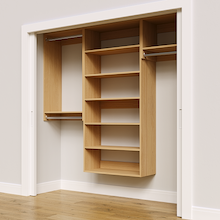 Natural oak 82.5-inch woodgrain Vista Total Closet Kit, angled view, empty, with tall hanging in a reach-in closet
