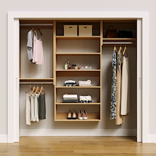 Natural oak 82.5-inch woodgrain Vista Total Closet Kit, front view in a reach-in closet, holding dresses
