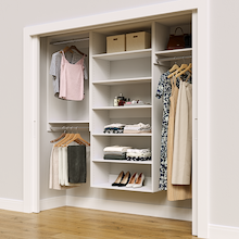 White 82.5-inch Vista Total Closet Kit in a reach-in closet with dresses, shoes, and handbags