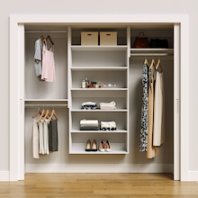 White 82.5-inch Vista Total Closet Kit, front view in a reach-in closet, holding dresses