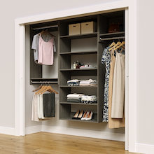 Grey 85.5-inch woodgrain Vista Total Closet Kit in a reach-in closet with dresses, shoes, and handbags