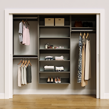 Grey 85.5-inch woodgrain Vista Total Closet Kit, front view in a reach-in closet, holding dresses