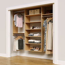 Natural oak 85.5-inch woodgrain Vista Total Closet Kit in a reach-in closet with dresses, shoes, and handbags