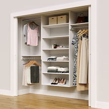 White 85.5-inch Vista Total Closet Kit in a reach-in closet with dresses, shoes, and handbags