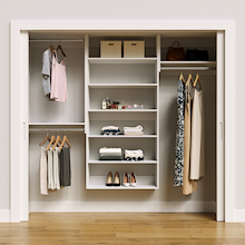 White 85.5-inch Vista Total Closet Kit, front view in a reach-in closet, holding dresses