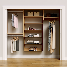 Natural oak 88.5-inch woodgrain Vista Total Closet Kit, front view in a reach-in closet, holding dresses