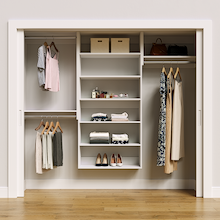 White 88.5-inch Vista Total Closet Kit, front view in a reach-in closet, holding dresses