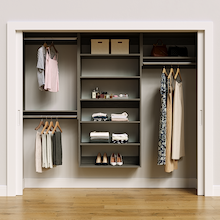 Grey 91.5-inch woodgrain Vista Total Closet Kit, front view in a reach-in closet, holding dresses