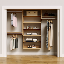 Natural oak 91.5-inch woodgrain Vista Total Closet Kit, front view in a reach-in closet, holding dresses