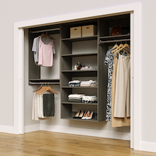 Grey 94.5-inch woodgrain Vista Total Closet Kit in a reach-in closet with dresses, shoes, and handbags