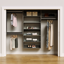 Grey 94.5-inch woodgrain Vista Total Closet Kit, front view in a reach-in closet, holding dresses
