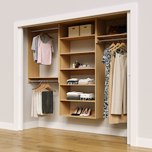 Natural oak 94.5-inch woodgrain Vista Total Closet Kit in a reach-in closet with dresses, shoes, and handbags