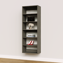Grey 24 inch closet organizer unit for space-saving storage in a modern apartment.