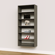 Grey 30 inch closet shelf tower for upright storage in a master bedroom.