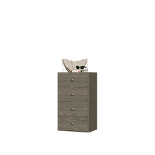 Grey closet drawer unit with slab fronts and top surface for jewelry or accessory storage.