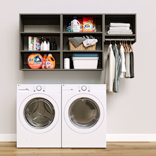 Grey Classic Laundry Kit featuring laundry hanging storage and overhead shelves installed above a washer and dryer to organize everyday laundry essentials.