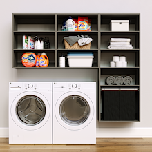 Grey Select Laundry Kit featuring a built-in pull-out hamper and upper shelves installed above a washer and dryer to organize everyday laundry essentials.