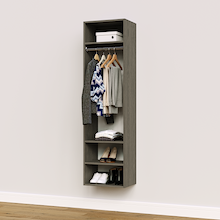 Grey hanging closet tower module with an upper shelf, hanging rod, and three lower shelves for jacket and coat storage.