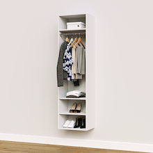 White hanging closet tower module with an upper shelf, hanging rod, and three lower shelves for folded clothes storage.