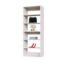 White 25.5 inch shelf tower for folded sweaters in a master closet.