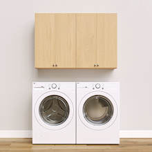 Natural Oak Basic Laundry Kit with storage doors and overhead shelving installed above a washer and dryer providing built-in laundry room storage. Yes