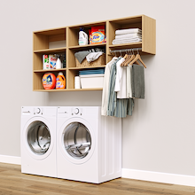 Natural Oak Classic Laundry Kit with a hanging rod and overhead shelving installed above a washer and dryer for organized laundry room storage.