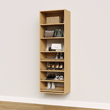 Natural oak shoe organizer with 4 slanted shelves for mixed shoe and boot collections in a walk-in closet.