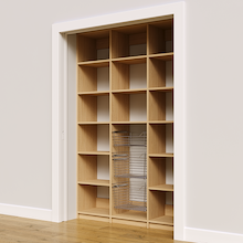 Three chrome wire baskets in 57 inch natural oak kitchen pantry shelving.
