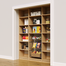 66 inch vertical pantry racks in natural oak with three wire baskets.