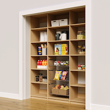 69 inch natural oak reach in pantry racks with three wire baskets for groceries.
