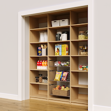 Natural oak 72 inch reach in pantry shelves with three wire storage baskets.
