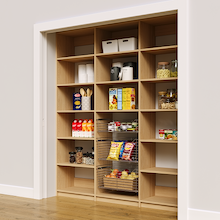 Natural oak 75 inch pantry rack with three wire baskets for storage.