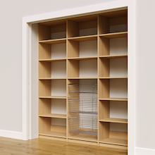 Three wire baskets in a 78 inch natural oak kitchen pantry.