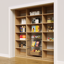 81 inch vertical pantry shelves in natural oak with three wire baskets.