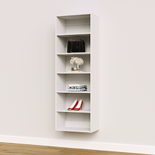 White 22.5 inch shelving tower for towels in a laundry room.