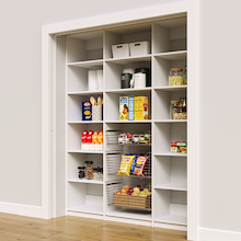 White 69 inch bulk pantry shelves with three pull-out wire storage baskets.