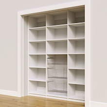 Three pull-out wire baskets in a 72 inch white pantry for reach in storage.