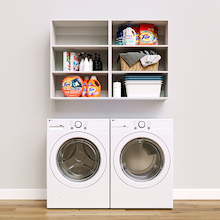 White Basic Laundry Kit featuring open overhead shelves installed above a washer and dryer to organize everyday laundry essentials. No