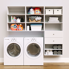 White Choice Laundry Kit featuring built-in drawer storage and upper shelves installed above a washer and dryer to organize everyday laundry essentials.