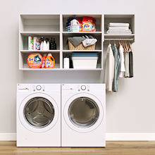 White Classic Laundry Kit featuring laundry hanging storage and overhead shelves installed above a washer and dryer to organize everyday laundry essentials.