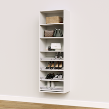 White shoe organizer with 4 slanted shelves for boots, heels, and sneakers in a single closet unit.