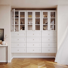 White 25.5 inch half closet doors with glass panels fully installed as part of a complete master closet system.