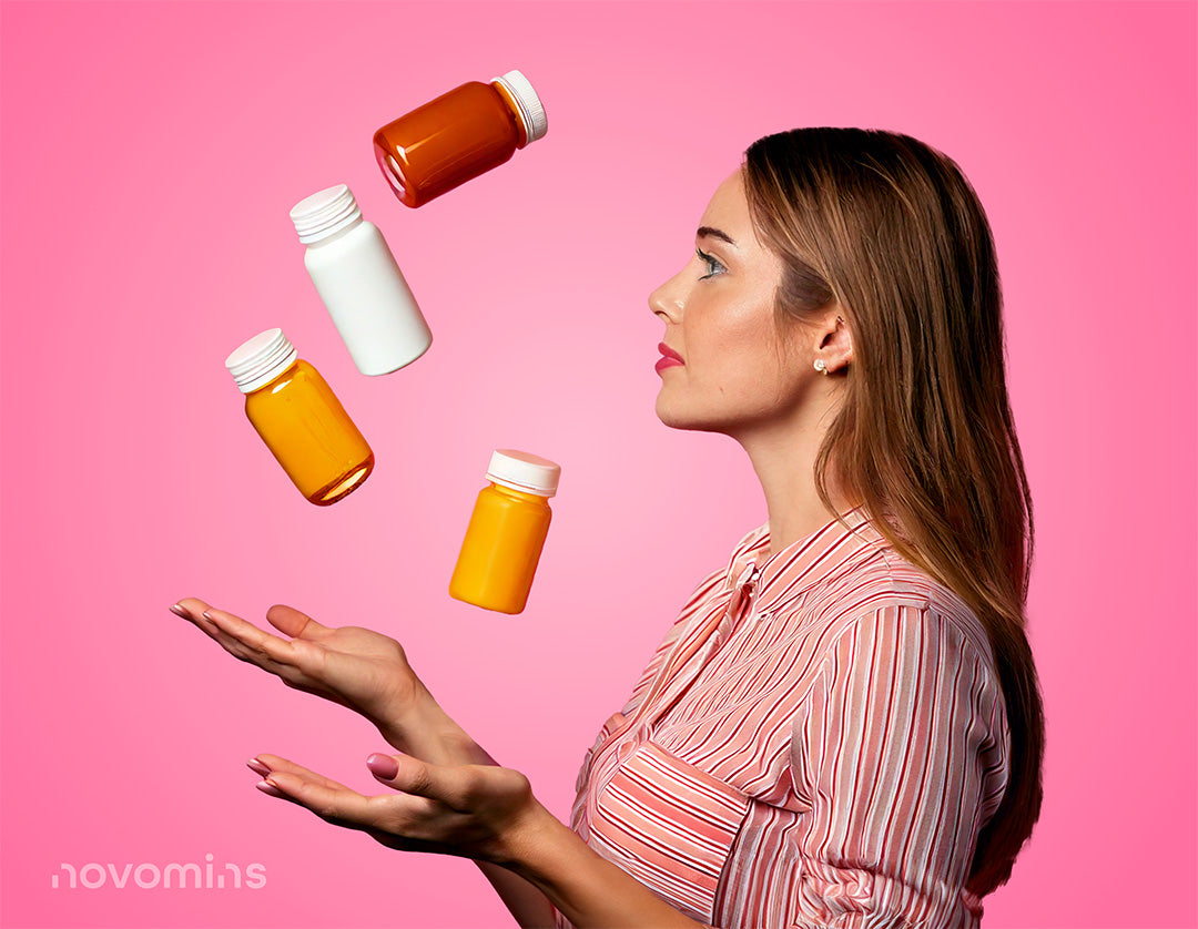 Woman juggling multiple supplement bottles