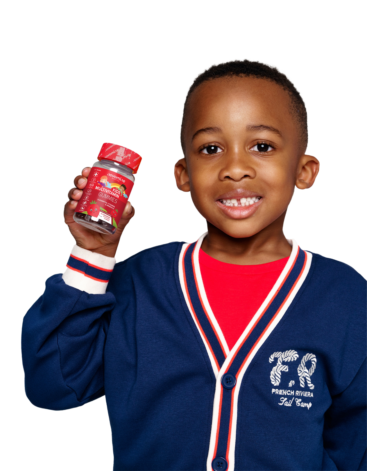 Image of a little boy holding a bottle of Novomins Kids’ Multi-vitamins with 13 essential vitamins and minerals.