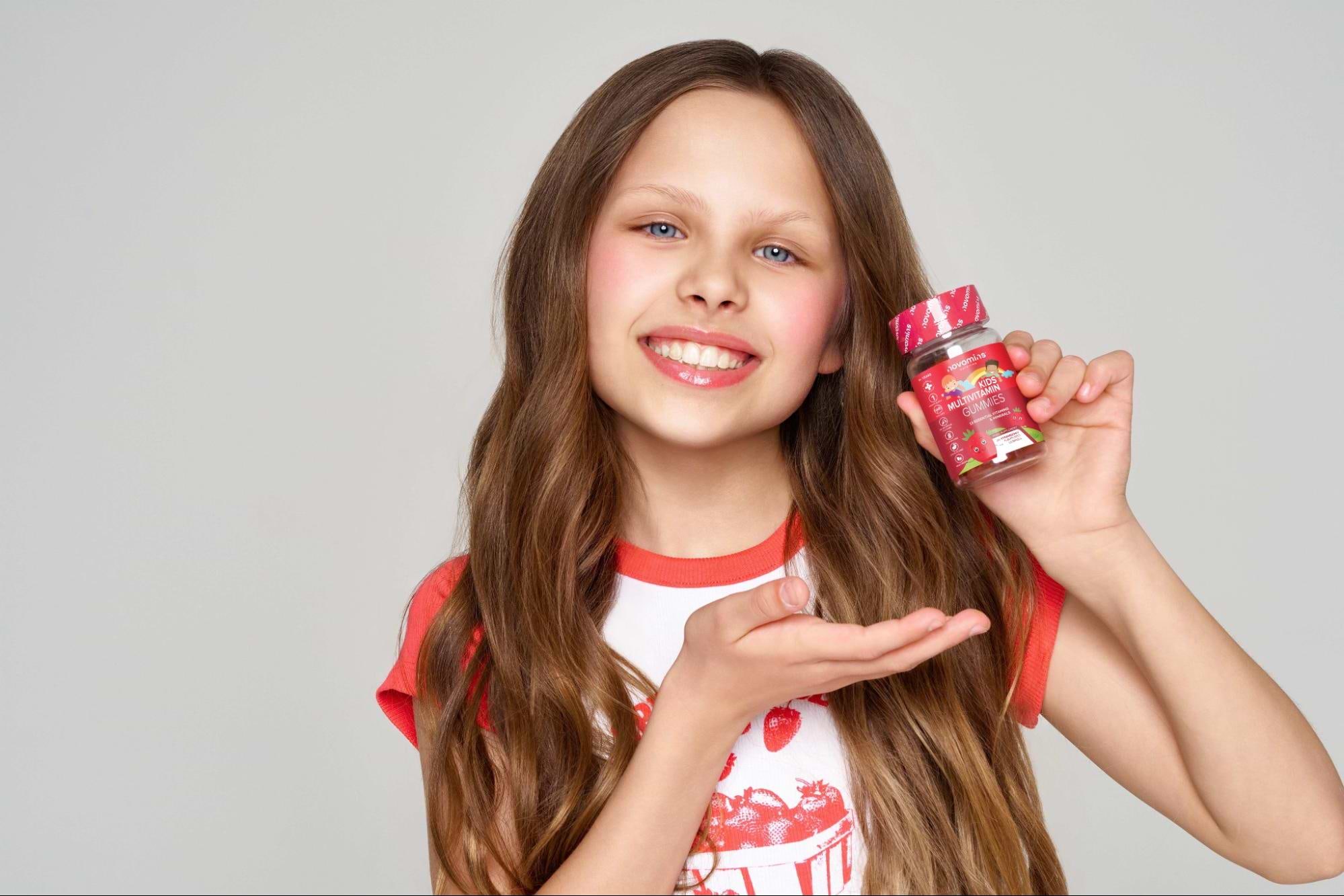 Image of child holding best vitamin gummies UK