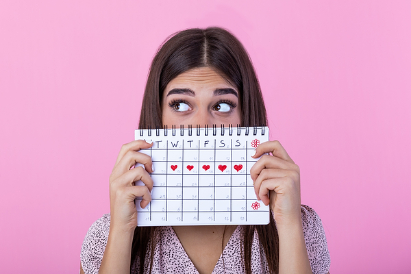 Woman who is about to come onto her period, struggling with fatigue and pain