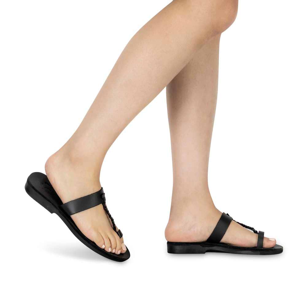 Model wearing Ara black, handmade leather slide sandals with toe loop