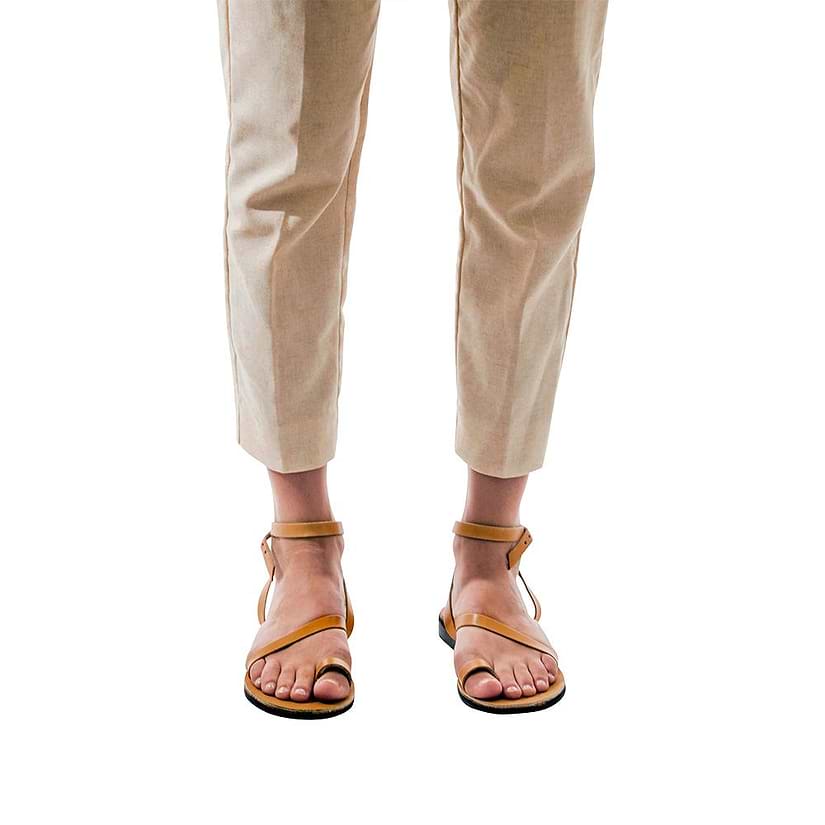 Model wearing Mara tan, handmade leather sandals with back strap and toe loop