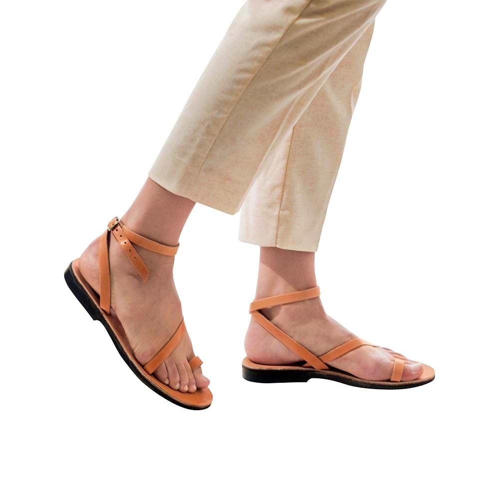 Model wearing Mara tan, handmade leather sandals with back strap and toe loop